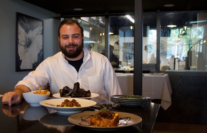 Andrew Garbarino IV, chef and owner, shows off some of the dishes on Bar Frenchman's menu.