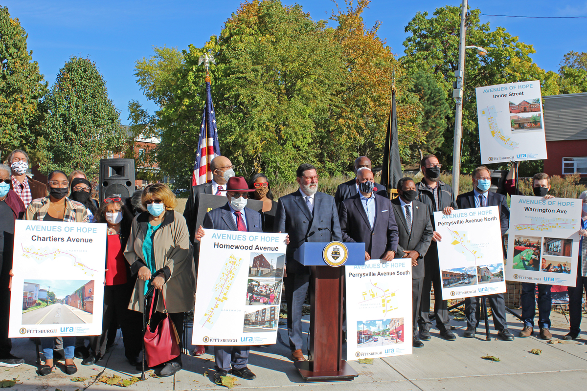 City of Pittsburgh officials and stakeholders hold posters of the various avenues that are part of the initiative.