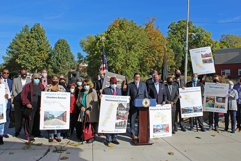City of Pittsburgh officials and stakeholders hold posters of the various avenues that are part of the initiative.