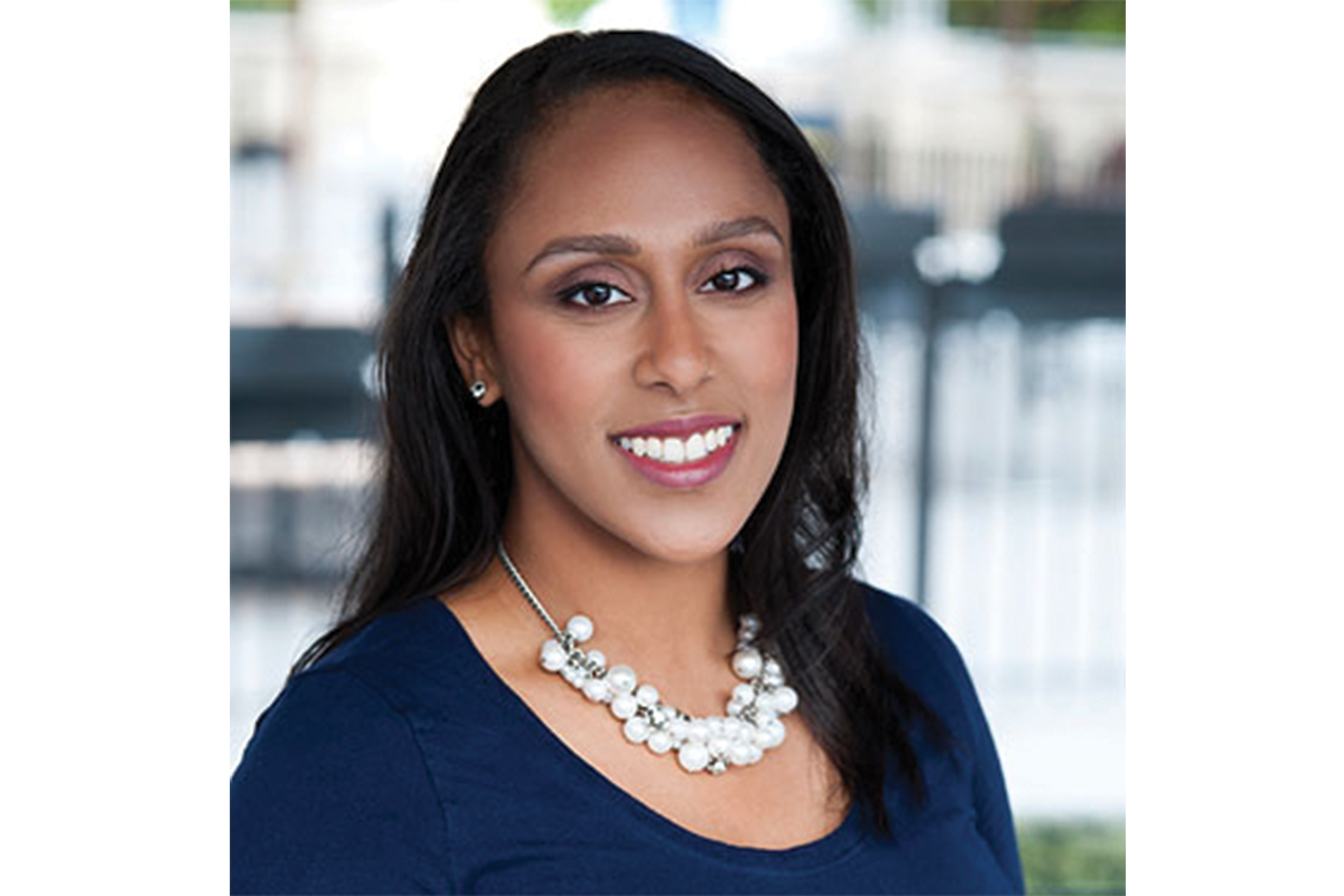 URA staff member Aster Teclay smiles in a headshot photo