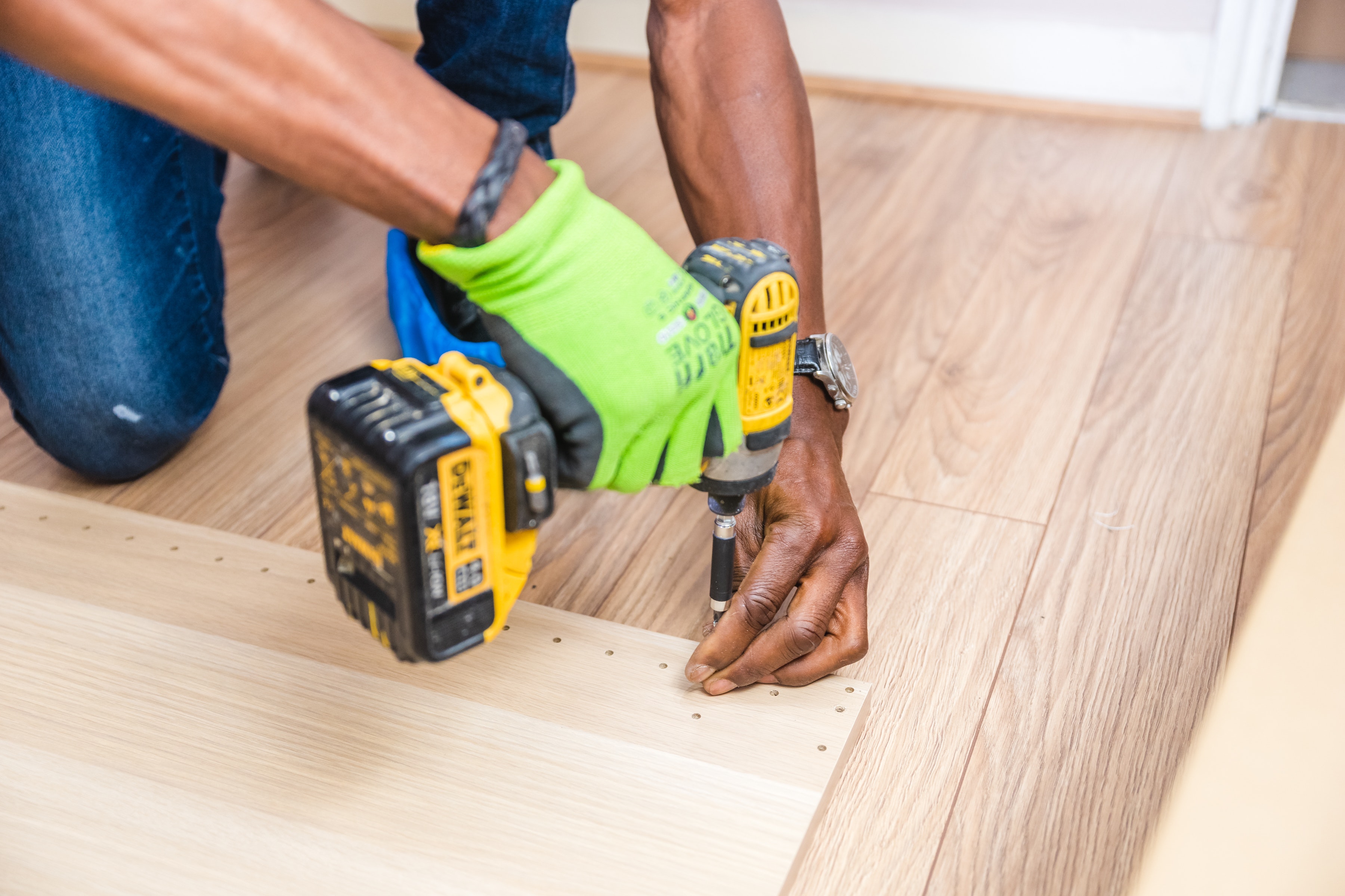 Hand of a contractor using a screw gun