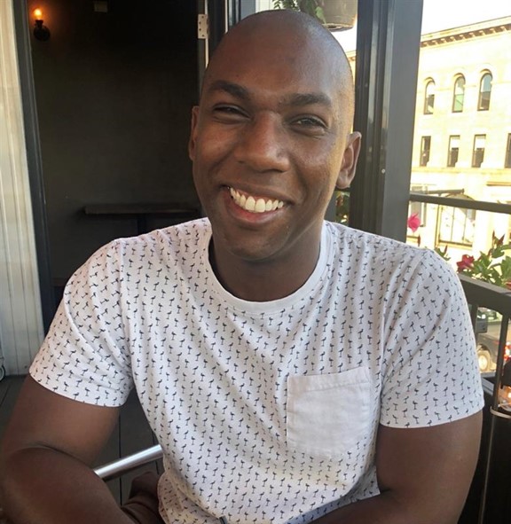 URA staff member Marcus Robinson smiles in a headshot photo