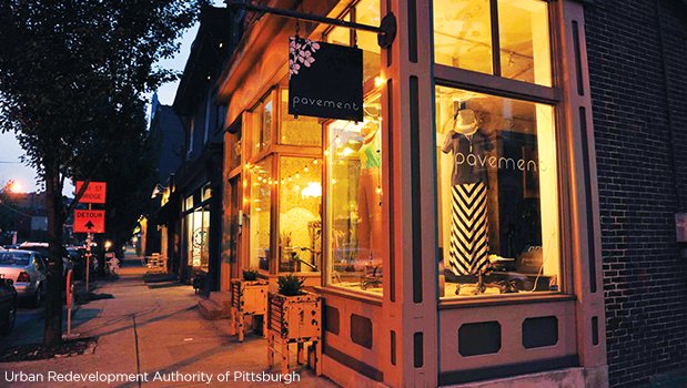 A storefront is illuminated at night in the Lawrenceville neighborhood business district