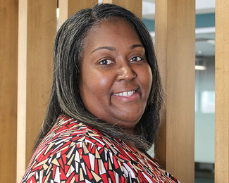 Headshot of Damara Carter, the Urban Redevelopment Authority of Pittsburgh's new Chief Financial Officer, smiling